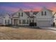 Charming two-story home featuring beige siding, green shutters, and a manicured lawn in a suburban neighborhood at 32 Colson Dr, Garner, NC 27529