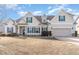 Attractive two-story home featuring beige siding, green shutters, and a well-manicured front yard in a quiet neighborhood at 32 Colson Dr, Garner, NC 27529