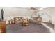 Cozy upstairs living room with plush carpeting, a ceiling fan, and plenty of natural light at 32 Colson Dr, Garner, NC 27529