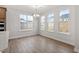 Bright dining area featuring three large windows and stylish light fixture at 347 N. Maple Walk Dr # 211, Garner, NC 27529