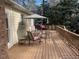 Cozy outdoor deck with chairs and table, surrounded by nature, creating a serene and relaxing atmosphere at 3616 Blue Ridge Rd, Raleigh, NC 27612