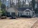 Charming single-story home with a front yard and driveway, surrounded by trees at 3616 Blue Ridge Rd, Raleigh, NC 27612