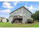 Rear view of home with a wood deck and a large yard at 378 Oak Alley Trl, Clayton, NC 27527