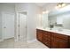 Bathroom with dual sinks, dark wood cabinets, and neutral tiling on the floor at 378 Oak Alley Trl, Clayton, NC 27527
