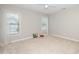 Neutral bedroom featuring plush carpet, two windows for light, and neutral walls at 378 Oak Alley Trl, Clayton, NC 27527