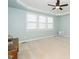 Tranquil bedroom featuring plush carpet, a tray ceiling, and plenty of natural light at 378 Oak Alley Trl, Clayton, NC 27527