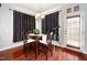 Comfortable dining space with wood floors, dark curtains and bright natural light at 378 Oak Alley Trl, Clayton, NC 27527