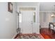 Bright foyer showcasing a white front door with glass panels and stylish decor, adjacent to hardwood flooring at 378 Oak Alley Trl, Clayton, NC 27527