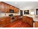 Modern kitchen boasts rich wood cabinets, stainless steel appliances, and hardwood floors, ideal for cooking at 378 Oak Alley Trl, Clayton, NC 27527