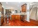 Spacious kitchen with wood cabinetry, stainless appliances, and hardwood flooring, offering a practical design at 378 Oak Alley Trl, Clayton, NC 27527
