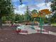 Large community playground with a variety of play structures and shaded seating areas at 378 Oak Alley Trl, Clayton, NC 27527