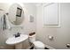 Cozy powder room features a pedestal sink, round mirror, and natural light from a nearby window at 378 Oak Alley Trl, Clayton, NC 27527