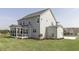 Backyard view of a two-story home with a screened-in porch at 3913 Berkeley Town Ln, Fuquay Varina, NC 27526