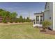 Spacious backyard with green lawn, privacy fence, and a covered porch, ideal for outdoor living at 3913 Berkeley Town Ln, Fuquay Varina, NC 27526