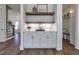 Stylish bar area with open shelving, under cabinet lighting, and plenty of storage space at 3913 Berkeley Town Ln, Fuquay Varina, NC 27526