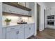 A modern bar area showcasing decor, wood shelves and marble countertops and stainless steel appliances at 3913 Berkeley Town Ln, Fuquay Varina, NC 27526