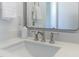 Bathroom vanity featuring a brushed-nickel faucet, white countertop, and a bottle of hand soap next to the mirror at 3913 Berkeley Town Ln, Fuquay Varina, NC 27526
