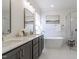 Bright bathroom with dual sinks, soaking tub, and glass-enclosed shower at 3913 Berkeley Town Ln, Fuquay Varina, NC 27526
