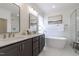 Bright bathroom with dual sinks, soaking tub, and glass-enclosed shower at 3913 Berkeley Town Ln, Fuquay Varina, NC 27526