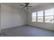 Spacious bedroom featuring large windows, a ceiling fan, and ample natural light at 3913 Berkeley Town Ln, Fuquay Varina, NC 27526