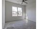 Bright bedroom features a ceiling fan and natural light from a double window with an outside view at 3913 Berkeley Town Ln, Fuquay Varina, NC 27526