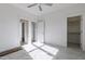 Clean bedroom with new carpet features a ceiling fan, closet, and natural light from a double window at 3913 Berkeley Town Ln, Fuquay Varina, NC 27526