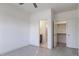 Clean, minimalist bedroom with a glimpse into the bathroom, closet, and simple color palette at 3913 Berkeley Town Ln, Fuquay Varina, NC 27526