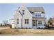 Charming two-story home featuring a brick facade, stylish windows, and a welcoming covered entryway at 3913 Berkeley Town Ln, Fuquay Varina, NC 27526