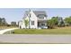 Charming two-story home with a well-manicured lawn and inviting front porch at 3913 Berkeley Town Ln, Fuquay Varina, NC 27526