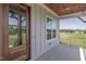 Covered front porch featuring a beautiful wood door and view at 3913 Berkeley Town Ln, Fuquay Varina, NC 27526