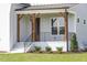 Inviting front porch with wooden pillars and a stylish black railing at 3913 Berkeley Town Ln, Fuquay Varina, NC 27526