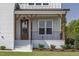 Charming front porch with decorative wooden beams and an elegant glass front door at 3913 Berkeley Town Ln, Fuquay Varina, NC 27526