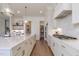 Chef's kitchen with custom cabinets, marble island, and high-end stainless steel appliances at 3913 Berkeley Town Ln, Fuquay Varina, NC 27526