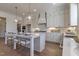 Spacious kitchen with white cabinets, pendant lighting, and stainless steel appliances at 3913 Berkeley Town Ln, Fuquay Varina, NC 27526