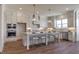 Modern kitchen featuring a large island with bar seating and stainless steel appliances at 3913 Berkeley Town Ln, Fuquay Varina, NC 27526