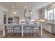 Contemporary kitchen with a large island, stainless steel appliances, and modern lighting at 3913 Berkeley Town Ln, Fuquay Varina, NC 27526