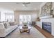 Cozy living room with fireplace, modern decor and access to screened-in porch at 3913 Berkeley Town Ln, Fuquay Varina, NC 27526