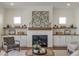 Beautiful living room showcasing a brick fireplace and decorative shelves at 3913 Berkeley Town Ln, Fuquay Varina, NC 27526