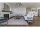 Bright living room with fireplace, white sofa, and hardwood floors at 3913 Berkeley Town Ln, Fuquay Varina, NC 27526