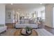 Living room with hardwood floors and an open view to kitchen and dining areas at 3913 Berkeley Town Ln, Fuquay Varina, NC 27526