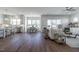 Open-concept living space with hardwood floors, modern furnishings, and plenty of natural light at 3913 Berkeley Town Ln, Fuquay Varina, NC 27526