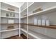 Walk-in pantry with custom shelving offering ample storage space with decor and containers at 3913 Berkeley Town Ln, Fuquay Varina, NC 27526
