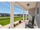 Inviting front porch showcasing two black rocking chairs and neighborhood views at 40 Thunder Valley Ct, Lillington, NC 27546