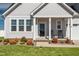 Charming front porch with rocking chairs and beautifully landscaped front yard at 40 Thunder Valley Ct, Lillington, NC 27546