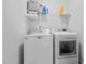 Bright laundry room includes modern washer and dryer, plus storage shelf at 40 Thunder Valley Ct, Lillington, NC 27546
