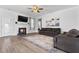 Modern living room features a fireplace with TV, lots of natural light, and an open floor plan at 40 Thunder Valley Ct, Lillington, NC 27546