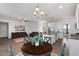 Open living space features modern decor, wood flooring, and a spacious kitchen with white cabinets at 40 Thunder Valley Ct, Lillington, NC 27546