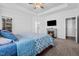 Cozy main bedroom features a fireplace, TV, and tray ceiling at 40 Thunder Valley Ct, Lillington, NC 27546