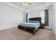 Bright main bedroom features tray ceilings, carpet flooring, and large windows with decorative gray curtains at 40 Thunder Valley Ct, Lillington, NC 27546