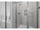 Elegant glass shower with marble-style tiling and recessed shower caddy at 40 Thunder Valley Ct, Lillington, NC 27546